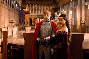 King Arthur and Queen Guinevere stand before the fabled Round Table.